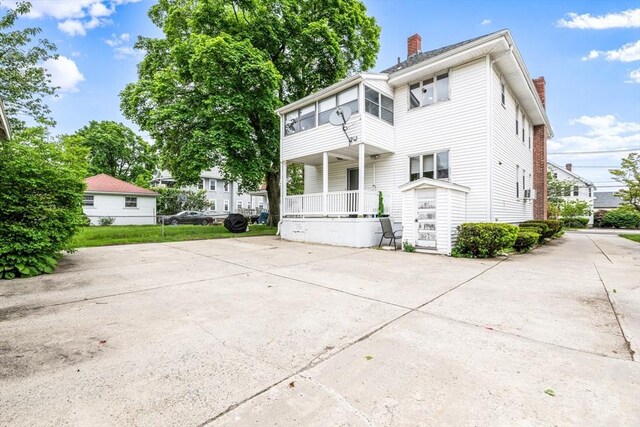 159 White St Unit 159, Belmont, MA 02478 - rear view of property featuring a chimney and covered porch