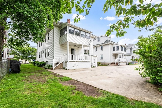 159 White St Unit 159, Belmont, MA 02478 - back of property with a porch, a chimney, a lawn, and a ceiling fan