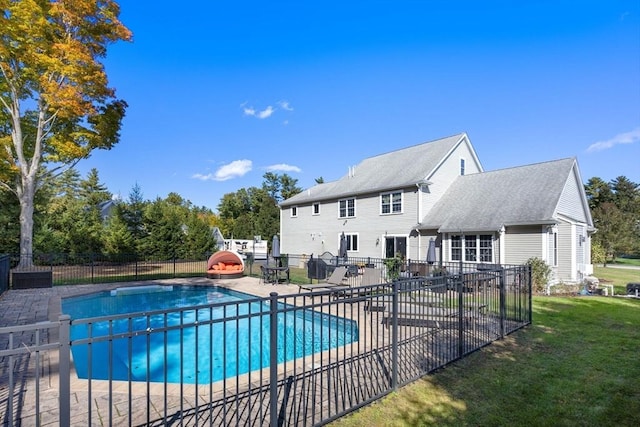 view of pool with a patio area and a yard