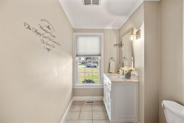 bathroom with tile patterned floors, crown molding, vanity, and toilet