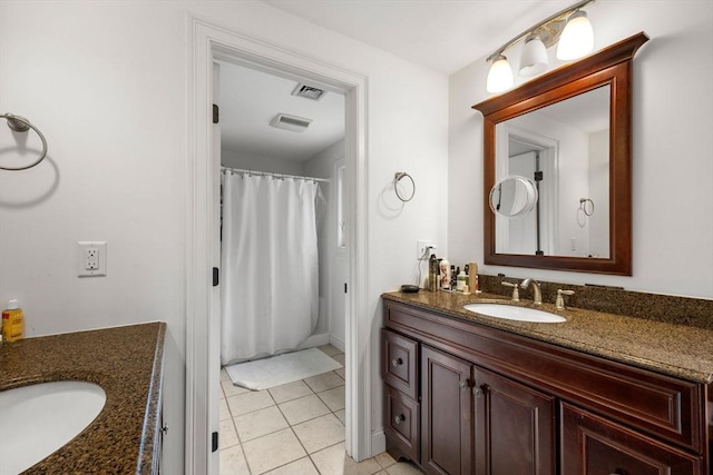 bathroom featuring tile patterned flooring and vanity