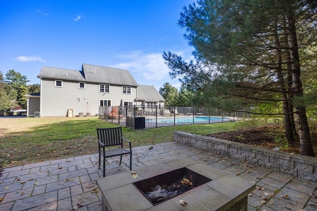 view of patio featuring a fenced in pool, central AC, and an outdoor fire pit