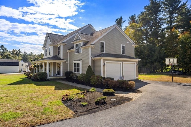 view of front of home with a porch, a garage, and a front lawn