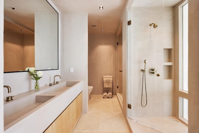 full bath with vanity, tile patterned floors, toilet, and a stall shower