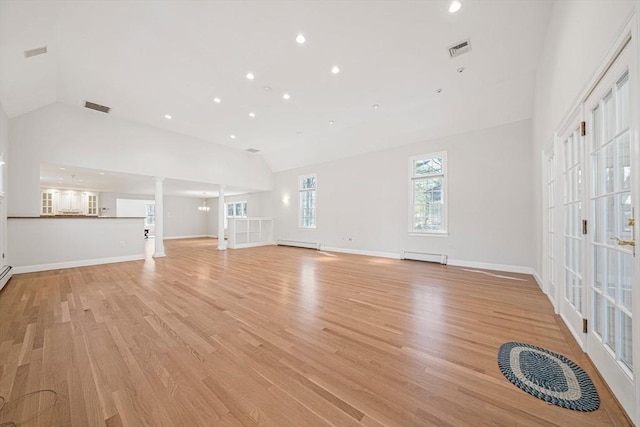 307 York St, Canton, MA 02021 - unfurnished living room with light wood-style floors, a baseboard radiator, lofted ceiling, and visible vents
