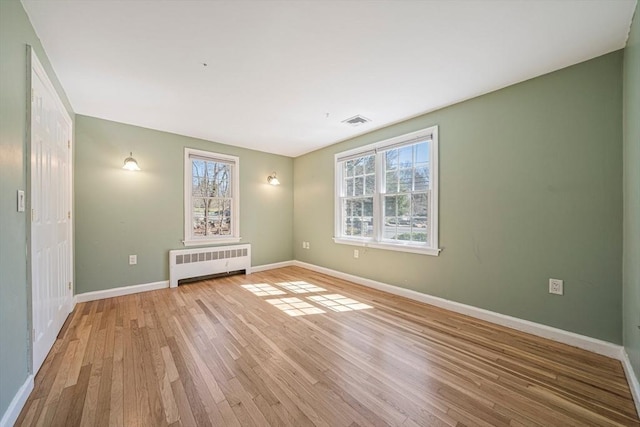 307 York St, Canton, MA 02021 - unfurnished room with visible vents, light wood-style flooring, radiator, and a wealth of natural light