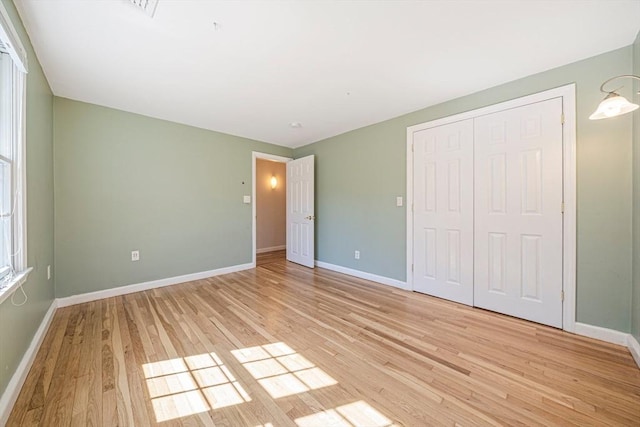 307 York St, Canton, MA 02021 - unfurnished bedroom featuring baseboards, a closet, and light wood finished floors