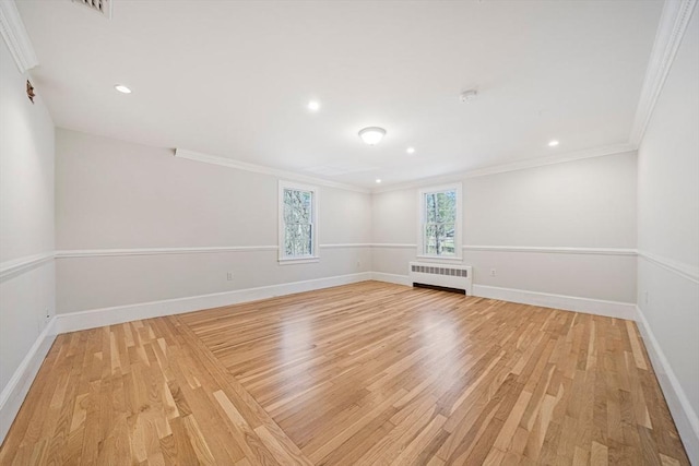 307 York St, Canton, MA 02021 - spare room with crown molding, baseboards, light wood-style flooring, and radiator heating unit
