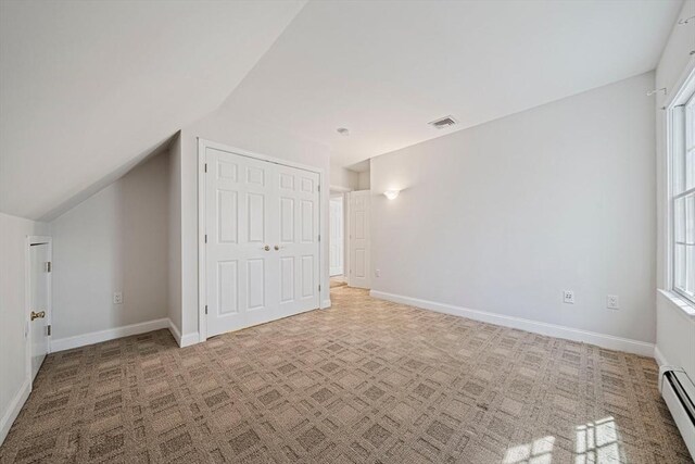 307 York St, Canton, MA 02021 - additional living space with vaulted ceiling, baseboards, a baseboard heating unit, and visible vents