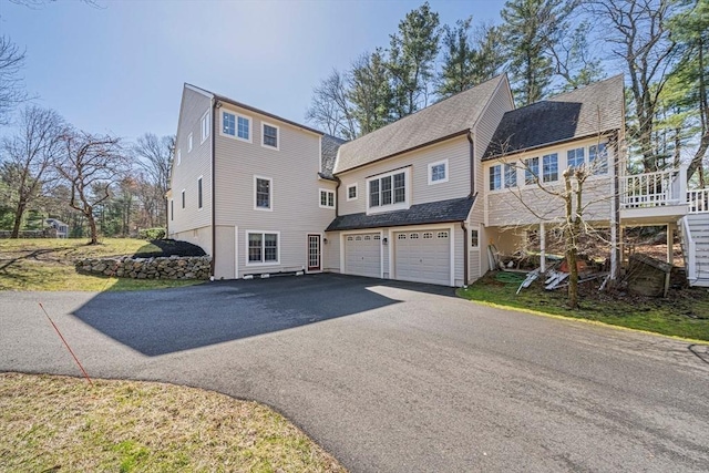 307 York St, Canton, MA 02021 - view of front facade with a garage, a shingled roof, and aphalt driveway
