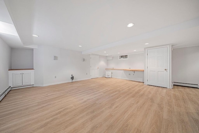 307 York St, Canton, MA 02021 - unfurnished living room with baseboards, baseboard heating, recessed lighting, and light wood-style flooring