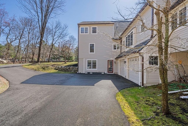 307 York St, Canton, MA 02021 - back of house featuring an attached garage and aphalt driveway
