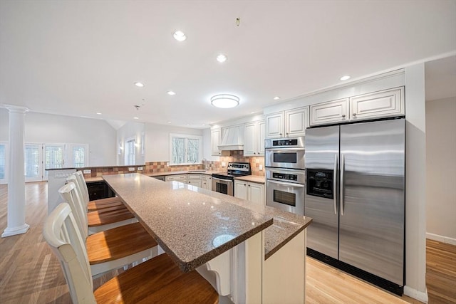 307 York St, Canton, MA 02021 - kitchen with decorative backsplash, a peninsula, recessed lighting, a sink, and stainless steel appliances