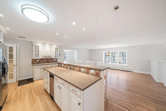 307 York St, Canton, MA 02021 - kitchen with a center island, light wood finished floors, baseboards, and a breakfast bar
