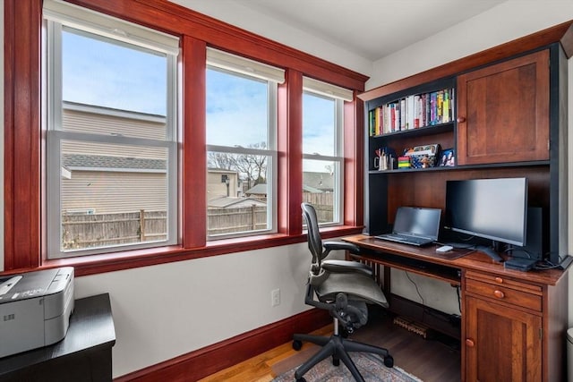 home office featuring baseboards and wood finished floors