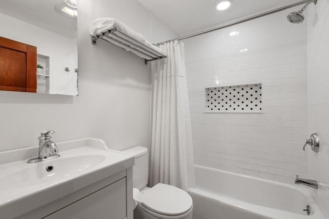 full bath featuring toilet, shower / bath combo with shower curtain, and vanity