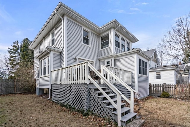 back of property featuring stairway, central AC unit, a deck, and fence