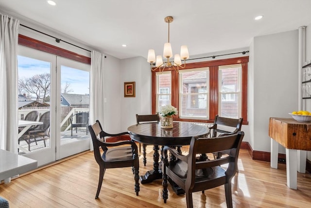 dining area featuring recessed lighting, baseboards, an inviting chandelier, and light wood finished floors