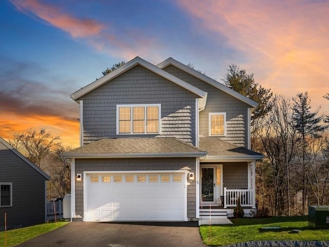 craftsman-style home featuring a yard and a garage