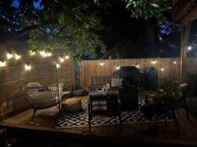 patio at twilight featuring fence