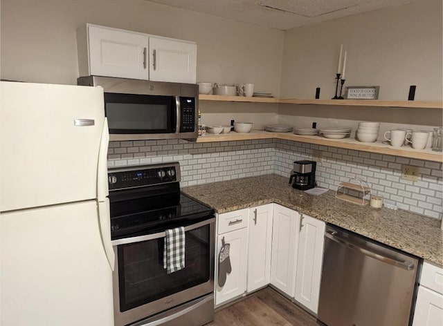 kitchen with open shelves, appliances with stainless steel finishes, white cabinets, and tasteful backsplash