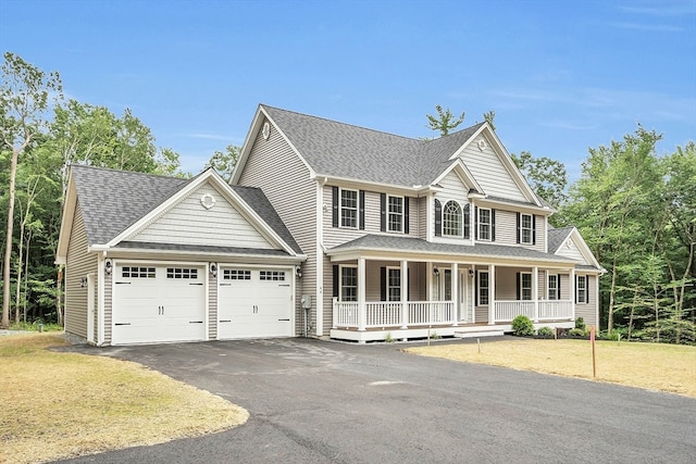 view of front of home with covered porch and a garage