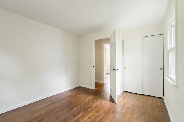 13 Karen Cir, Holliston, MA 01746 - unfurnished bedroom featuring wood finished floors, baseboards, and a closet