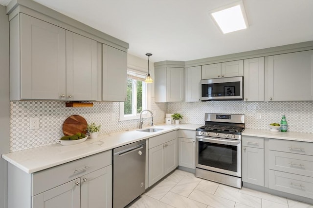 13 Karen Cir, Holliston, MA 01746 - kitchen featuring stainless steel appliances, gray cabinetry, a sink, and backsplash