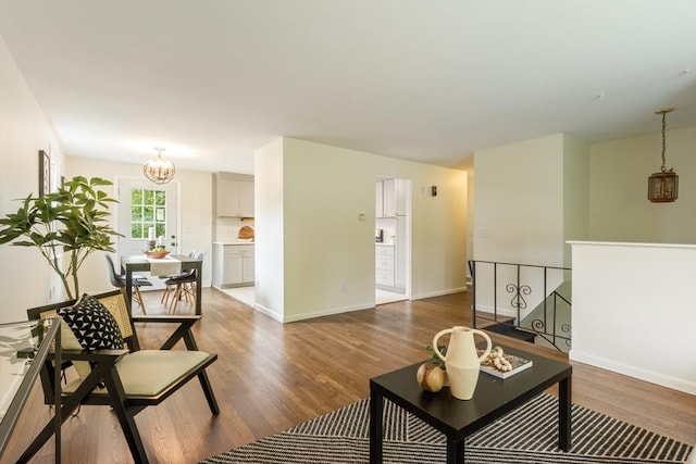 13 Karen Cir, Holliston, MA 01746 - living room with wood finished floors, a chandelier, and baseboards