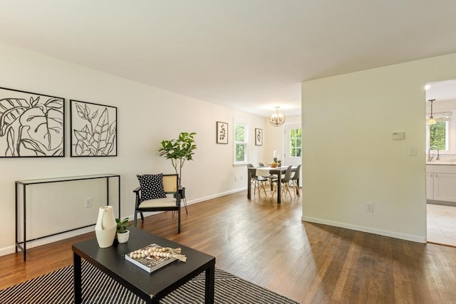 13 Karen Cir, Holliston, MA 01746 - living room with a chandelier, wood finished floors, and baseboards