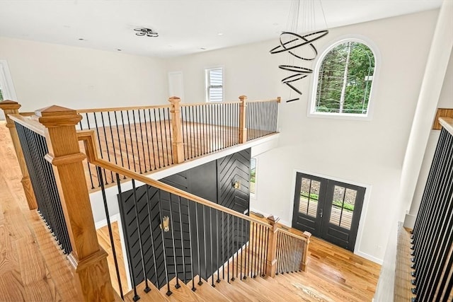 12 Martin St, Carlisle, MA 01741 - staircase featuring wood finished floors, healthy amount of natural light, and french doors