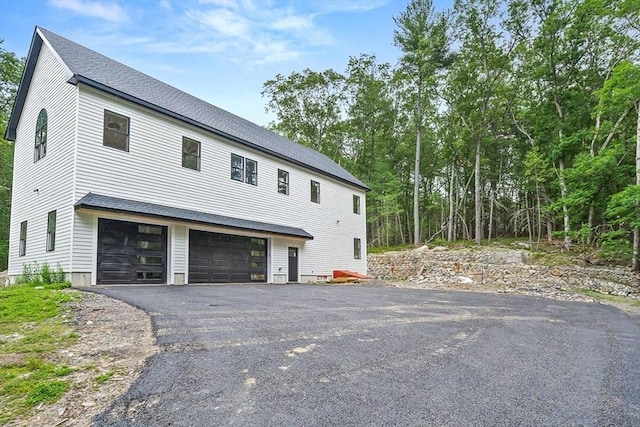 12 Martin St, Carlisle, MA 01741 - view of property exterior with an attached garage and driveway