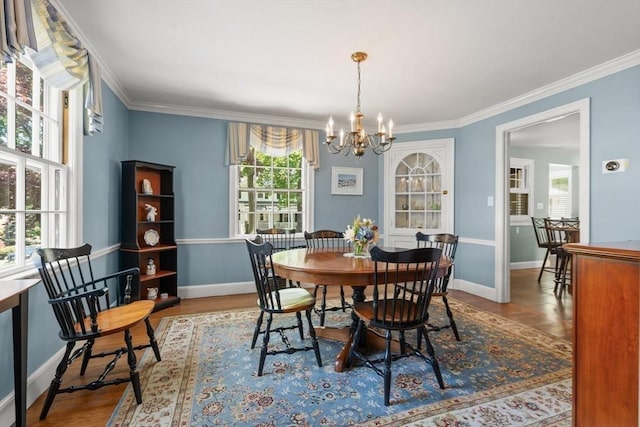 16 Bailey Ln, Dedham, MA 02026 - dining area featuring a chandelier, baseboards, ornamental molding, and wood finished floors