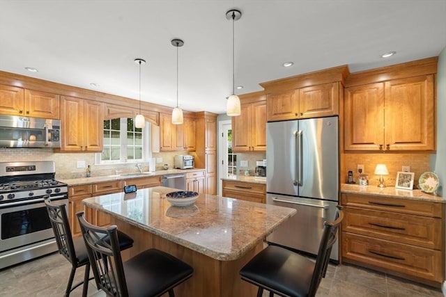 16 Bailey Ln, Dedham, MA 02026 - kitchen with appliances with stainless steel finishes, a sink, a breakfast bar, light stone countertops, and recessed lighting