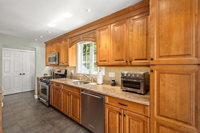16 Bailey Ln, Dedham, MA 02026 - kitchen featuring stainless steel appliances, a sink, tasteful backsplash, light stone countertops, and brown cabinetry