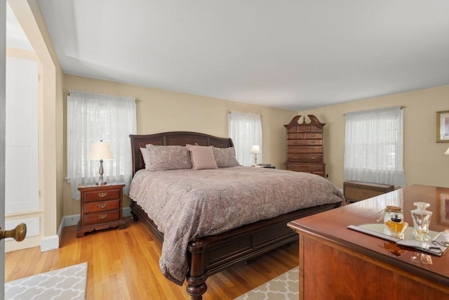 16 Bailey Ln, Dedham, MA 02026 - bedroom with multiple windows, light wood finished floors, and baseboards