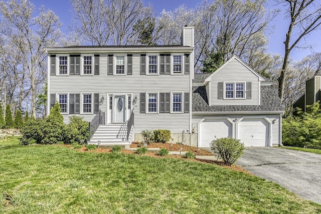 56 Ireta Rd, Shrewsbury, MA 01545 - colonial-style house with a chimney, driveway, an attached garage, and a front lawn