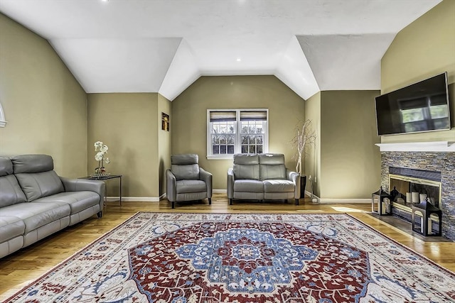 56 Ireta Rd, Shrewsbury, MA 01545 - living room with lofted ceiling, wood finished floors, baseboards, and a fireplace