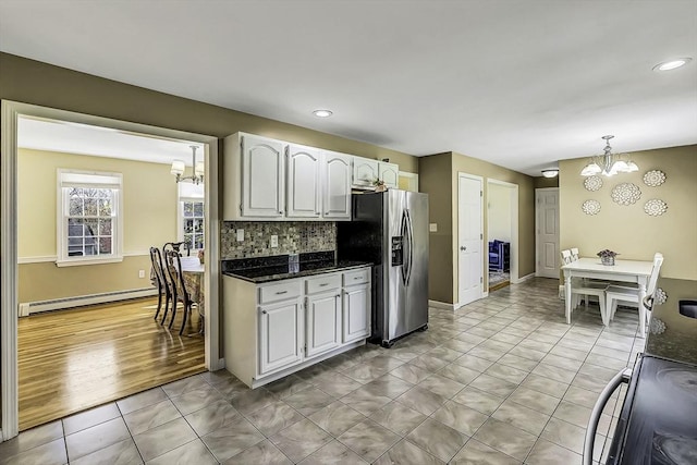 56 Ireta Rd, Shrewsbury, MA 01545 - kitchen with a baseboard heating unit, stainless steel fridge with ice dispenser, a chandelier, backsplash, and white cabinetry