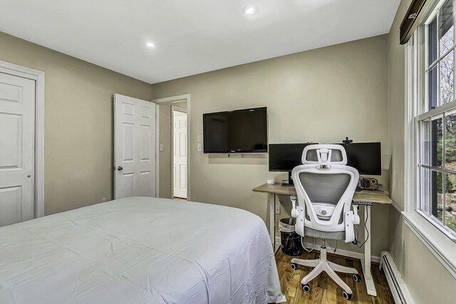 56 Ireta Rd, Shrewsbury, MA 01545 - bedroom featuring a baseboard heating unit, wood finished floors, multiple windows, recessed lighting, and baseboards