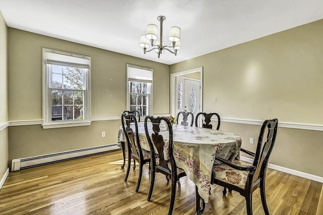 56 Ireta Rd, Shrewsbury, MA 01545 - dining room featuring baseboard heating, a chandelier, wood finished floors, and baseboards