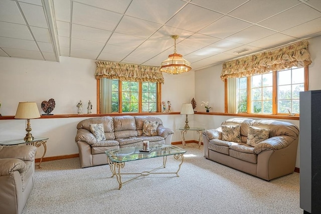 carpeted living room featuring a healthy amount of sunlight and a notable chandelier