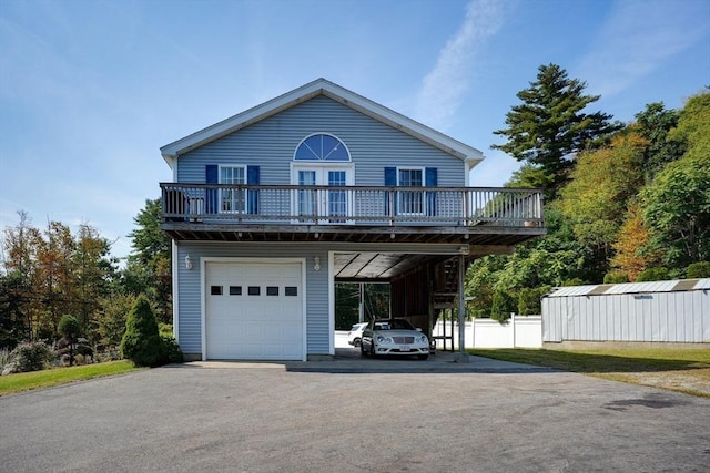 view of front of property featuring a wooden deck, a carport, and a garage