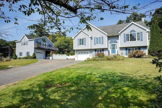 split foyer home featuring a front lawn and a garage