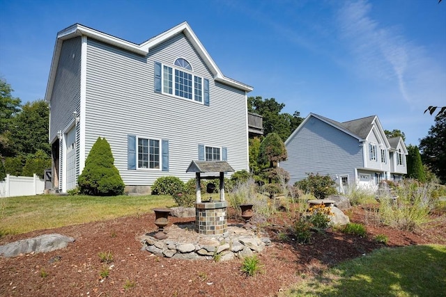 rear view of property featuring a lawn and a garage