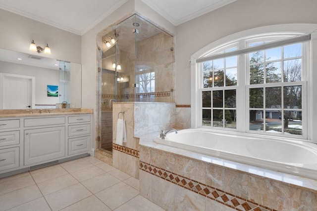 bathroom featuring a garden tub, ornamental molding, a shower stall, tile patterned flooring, and vanity