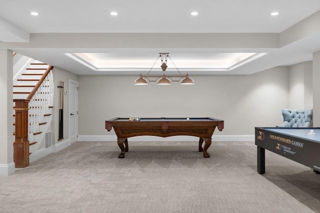 recreation room with recessed lighting, a tray ceiling, baseboards, and carpet