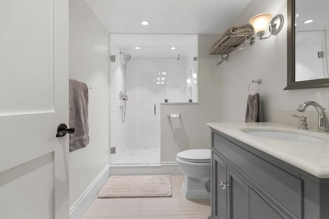 bathroom with vanity, baseboards, recessed lighting, a shower stall, and toilet