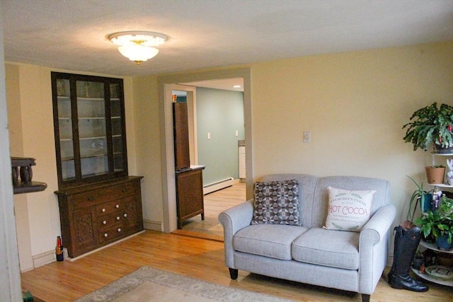 living room featuring light wood-type flooring and baseboard heating