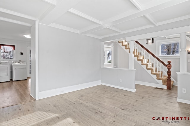 unfurnished living room featuring hardwood / wood-style flooring, coffered ceiling, washer and clothes dryer, and beamed ceiling